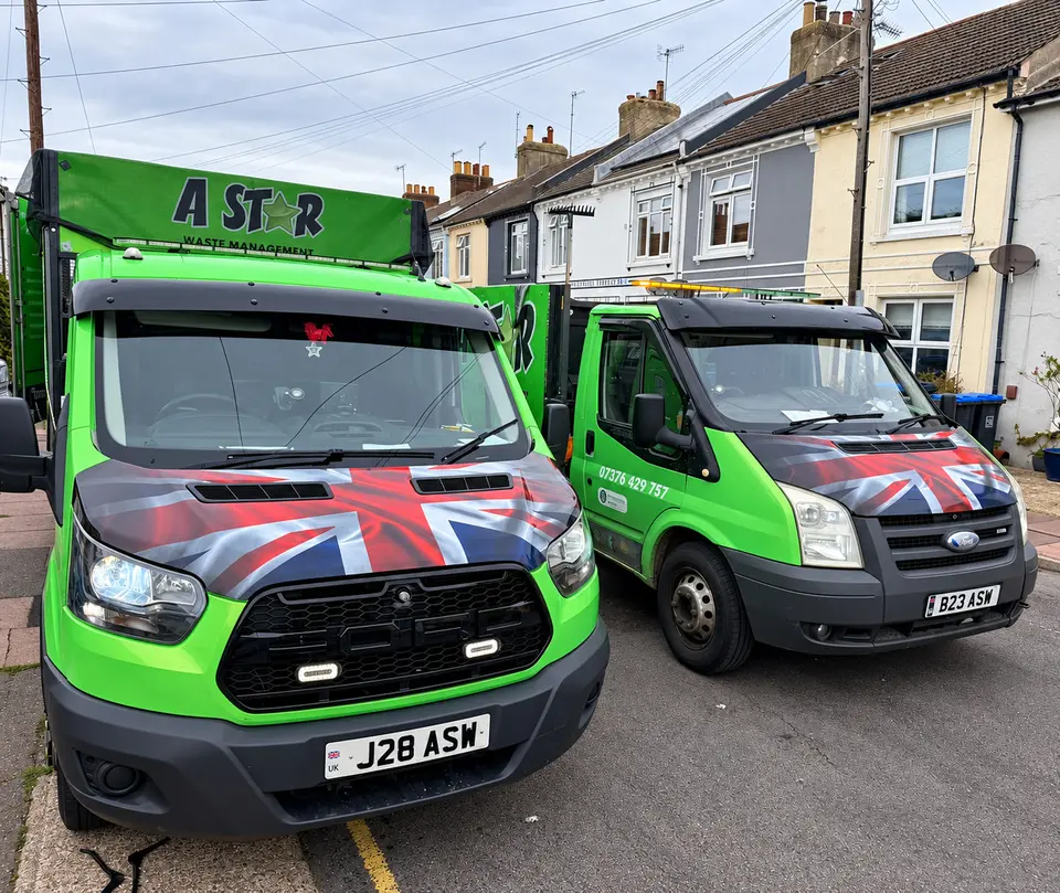 Two A Star vans with Union Jack bonnets on a terraced residential street