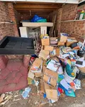 Before: a brick garage filled with cardboard boxes and clutter